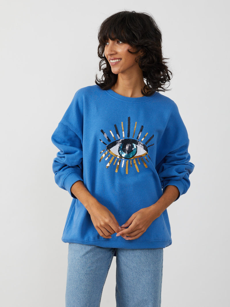 <img ="Evil Eye_Sweatshirt.png" alt="Evil Eye Sweatshirt Overzised Blue Color gold sequences"