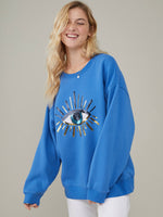 <img ="Evil Eye_Sweatshirt.png" alt="Evil Eye Sweatshirt Overzised Blue Color gold sequences"